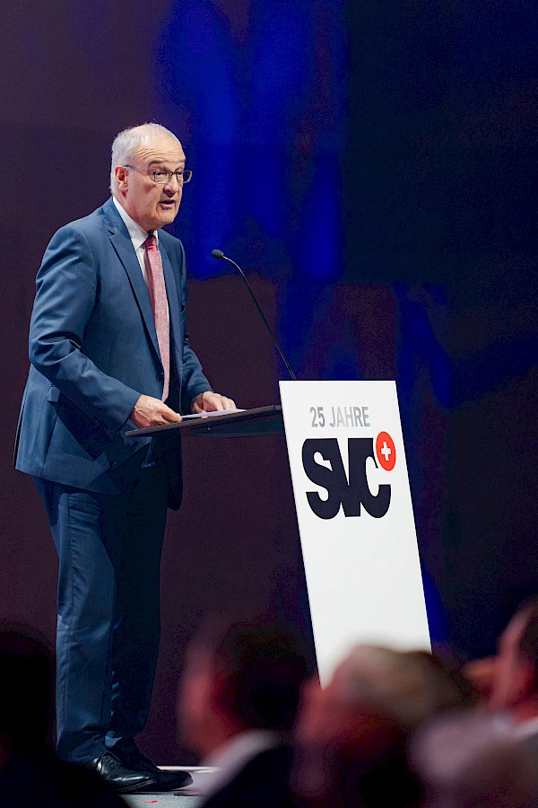 Eventfotograf Festhalle Bern: Bundesrat Guy Parmelin hält am Pult „25 Jahre SVC" seine Rede vor dem Publikum